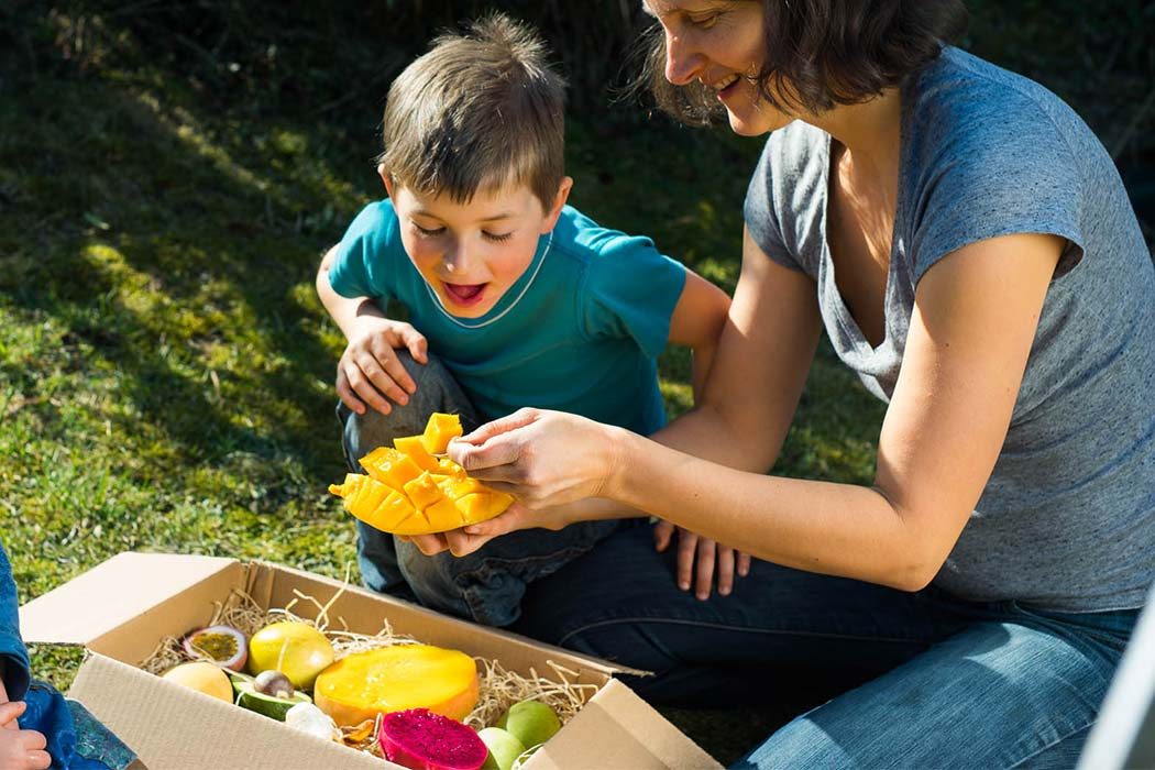 Family eating exotic fruits